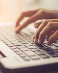 Fingers typing on a laptop keyboard to join the Patient Support Community.